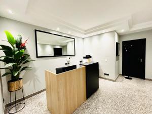 an office with a mirror and a potted plant at Les Suites Luxury Bari Certified Italian Excellence in Bari