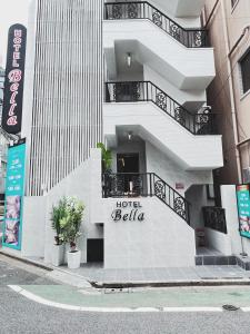 a hotel bella sign on the side of a building at Exquisite business hotel Bella in Tokyo