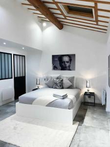 a white bedroom with a bed with a book on it at Amazing Résidence proche Galeries Lafayette in Paris