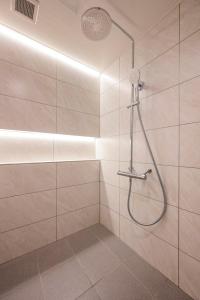 a bathroom with a shower with a shower head at Exquisite business hotel Bella in Tokyo