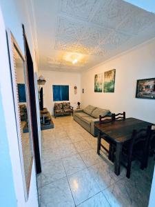 a living room with a couch and a table at Casa da Mãe Barra Grande in Maragogi