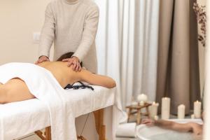 a woman getting a massage in a spa salon at WelcHome - Suites - in Perugia