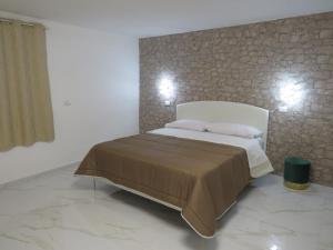 a bedroom with a bed with two pillows at Tortora house in Naples