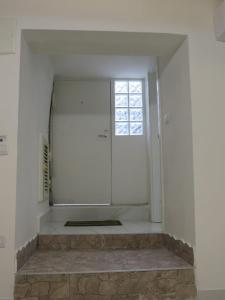 a white room with a window and a shower at Tortora house in Naples