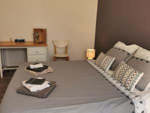 a bedroom with a bed with two towels on it at Chambre de Bajolle in Fourcès