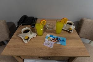 a wooden table with two cups of coffee on it at Smestaj & Spa Protić in Šabac