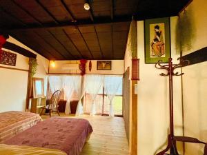 a bedroom with two beds and a room with a window at vintagehouse1925Bali - Vacation STAY 14502 in Nagano