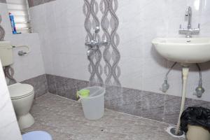 a bathroom with a toilet and a sink at 1 Room for 4 Guests OR 2 BHK for 4 to 10 Guests with AC for Families in Hyderabad