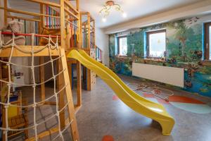 a childs room with a slide and a play area at Apartmány pro rodiny s dětmi - Permoník in Dolní Malá Úpa