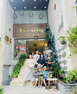a family posing in front of a building at Yen Vang Hotel & Apartment Nha Trang in Nha Trang