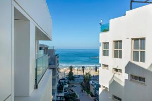 a view of the ocean from between two buildings at Jewel Boutique Hotel by The Beach in Tel Aviv