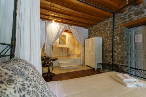 a bedroom with a bed and a table in a room at Nereids Guesthouse in Hydra