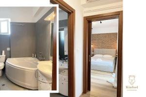 a bathroom with a tub and a toilet and a bed at Kinfeels' Suite ( M2 ) in Larisa +8 photos