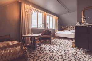 a bedroom with a bed and a table and a window at Villa Havblikk Tromsø in Tromsø