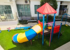 a playground with a slide in a yard at Dpulze Comfy Homestay, 1-5 Pax - DP3 in Cyberjaya
