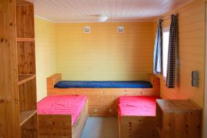 a small room with two beds in a cabin at Circus Fantasia in Rostock