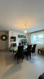 a living room with a dining room table and chairs at Résidence Les Balcons du Pic d'Anie in Arette