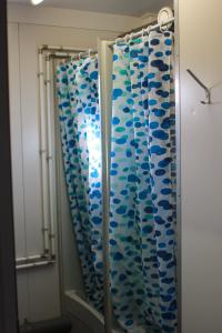 a shower curtain with blue fishes on it in a bathroom at Circus Fantasia in Rostock