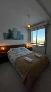 a bedroom with a large bed with two towels on it at Appartements du Pic d'Anie in Arette