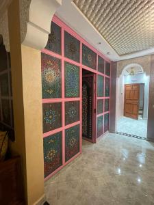 a room with a wall with colorful glass doors at Maison Moussaoui in Meknès