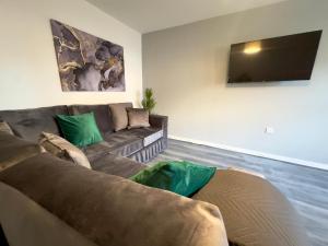uma sala de estar com um sofá e uma televisão de ecrã plano em Wallis House by Blue Skies Stays em Stockton-on-Tees