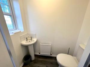 a bathroom with a sink and a toilet at Wallis House by Blue Skies Stays in Stockton-on-Tees