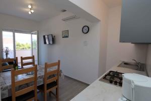 a kitchen with a table and a counter top at Apartment in Silo/Insel Krk 13440 in Šilo