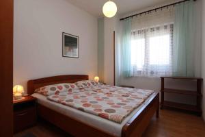 a bedroom with a large bed and a window at Apartment in Silo/Insel Krk 13440 in Šilo