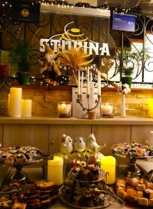 a display of pastries and other food on a shelf at Stupina in Braşov