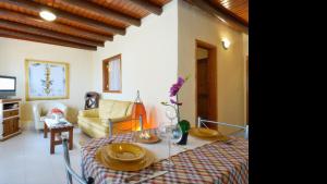 a living room with a table and a couch at Apartment Punta di Mare Punta Mujeres By PVL in Punta de Mujeres
