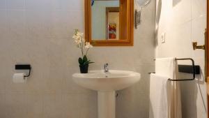 a white bathroom with a sink and a mirror at Apartment Punta di Mare Punta Mujeres By PVL in Punta de Mujeres +16 photos