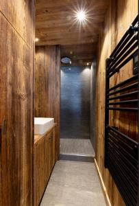 a wooden bathroom with a sink and a shower at Modern apartment in Megeve near ski lifts in Megève