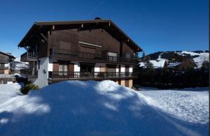 a pile of snow in front of a house at Modern apartment in Megeve near ski lifts in Megève
