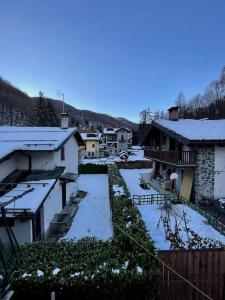 a view of a yard with snow covered buildings at Villa Gatti [Limone Centro] in Limone Piemonte