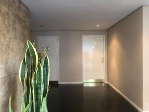 a hallway with a plant in front of a door at GATE Recoleta in Buenos Aires