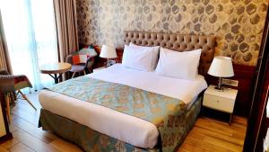 a bedroom with a large bed with two lamps at Old Port Hotel in Istanbul