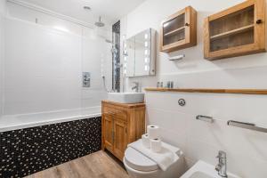 a bathroom with a toilet and a sink and a shower at Executive 4 Bedroom Town House in Canada Water FREE WIFI & PARKING by City Stay Aparts London in London