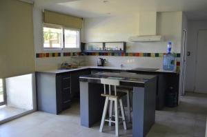 a kitchen with a island in the middle of it at Casa con gran parque y pileta in General Alvear