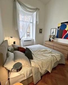 a large bed in a room with a window at Robins Nest in The City Center in Maribor