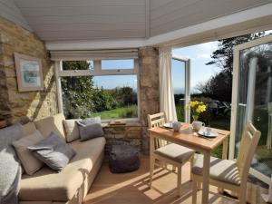 a living room with a couch and a table at 1 Bed in Isle of Purbeck IC131 in Worth Matravers