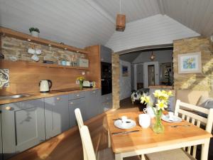 a kitchen and dining room with a wooden table at 1 Bed in Isle of Purbeck IC131 in Worth Matravers