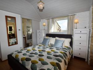 a bedroom with a large bed and a window at 1 Bed in Isle of Purbeck IC131 in Worth Matravers