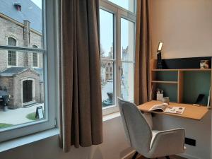 an office with a desk and a large window at B&B Anna's in Bruges