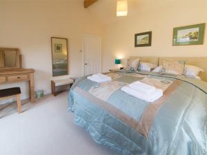 a bedroom with a large bed and a fireplace at 2 Bed in Harrogate District HH087 in Stainburn