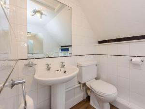a white bathroom with a toilet and a sink at 1 Bed in Tenterden 66342 in Tenterden +16 photos