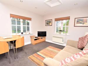 a living room with a couch and a table at 1 Bed in Cley NCC04 in Cley next the Sea