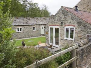 an image of a stone cottage with a garden at 1 bed in Bedale G0094 in Crakehall