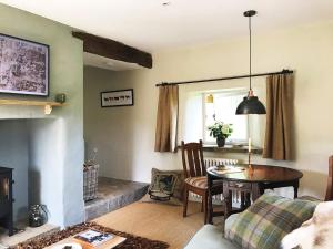 a living room with a table and a fireplace at 1 Bed in Goathland G0140 in Goathland