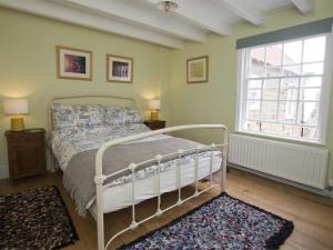 a bedroom with a white bed and a window at 2 Bed in Robin Hoods Bay G0085 in Robin Hood's Bay