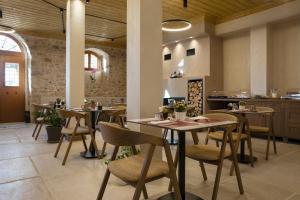 a restaurant with a table and chairs in a room at Μikri Arktos Boutique Hotel in Dhimitsana